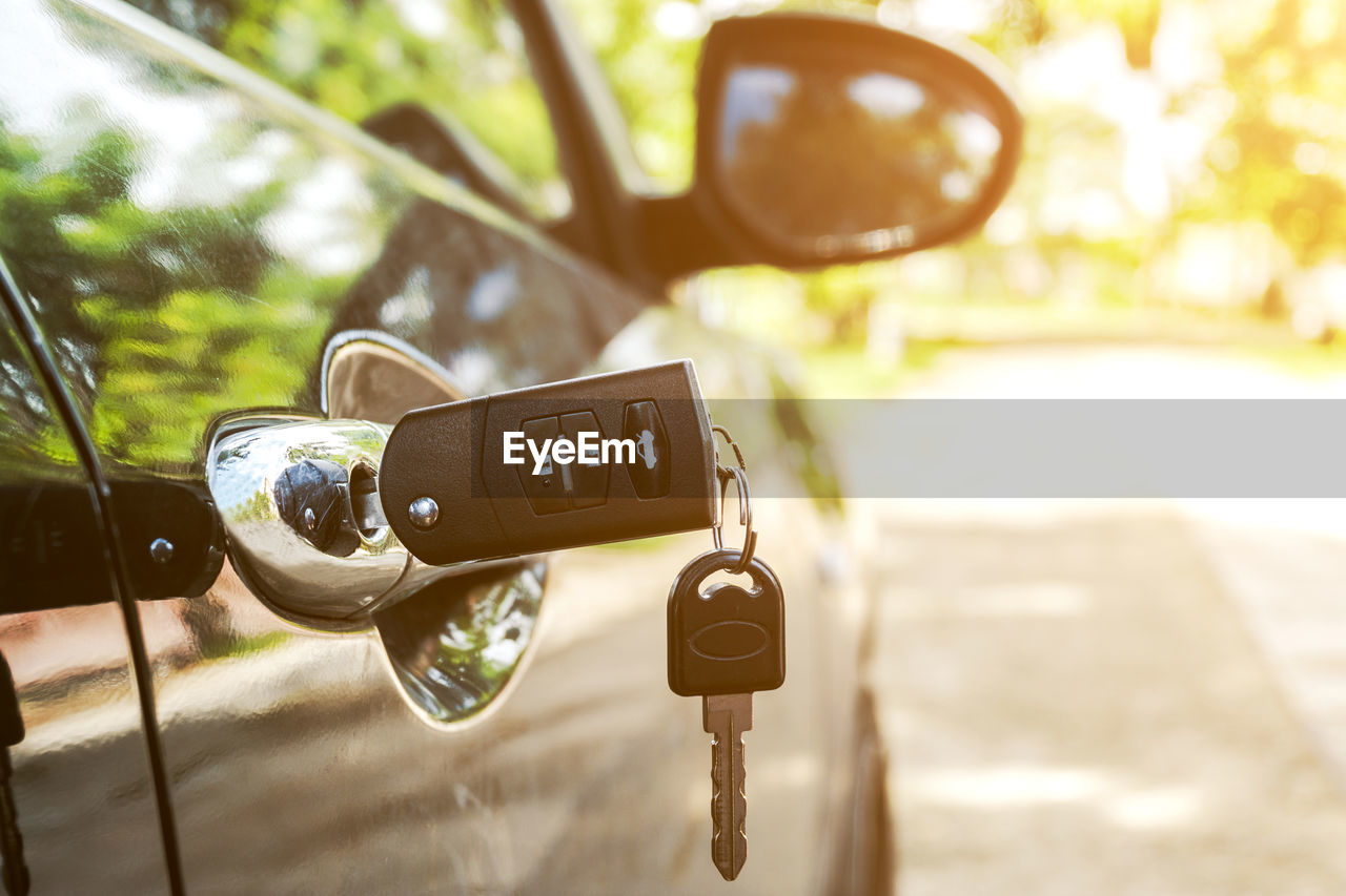 Close-up of key on car door