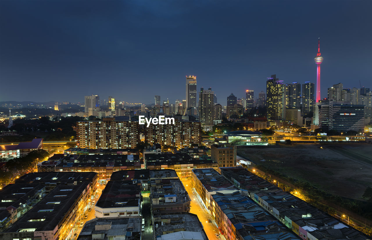 Menara kuala lumpur tower with cityscape against sky at dusk