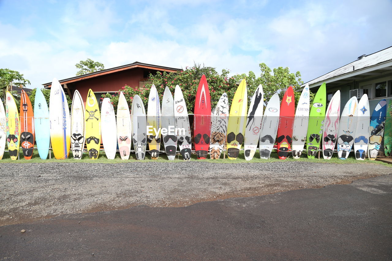 Surfboards on beach against sky