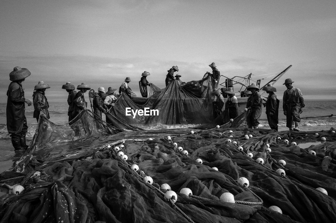 FISHING NET ON BEACH AGAINST SKY