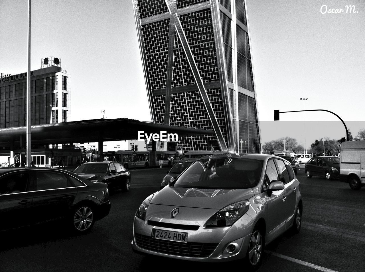 CARS ON STREET BY BUILDINGS AGAINST SKY