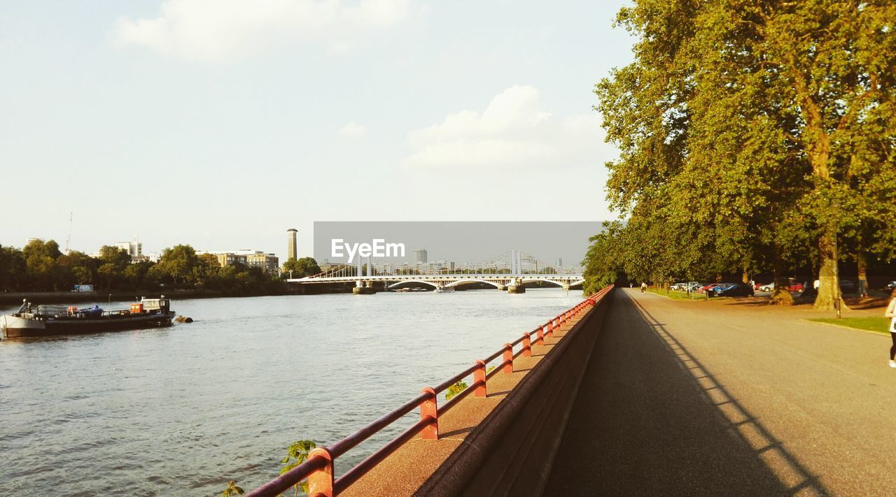 Road by river against sky