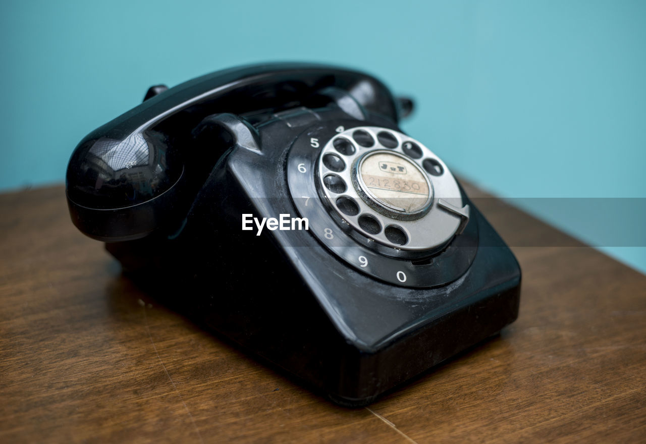 Close-up of old-fashioned phone on wooden table