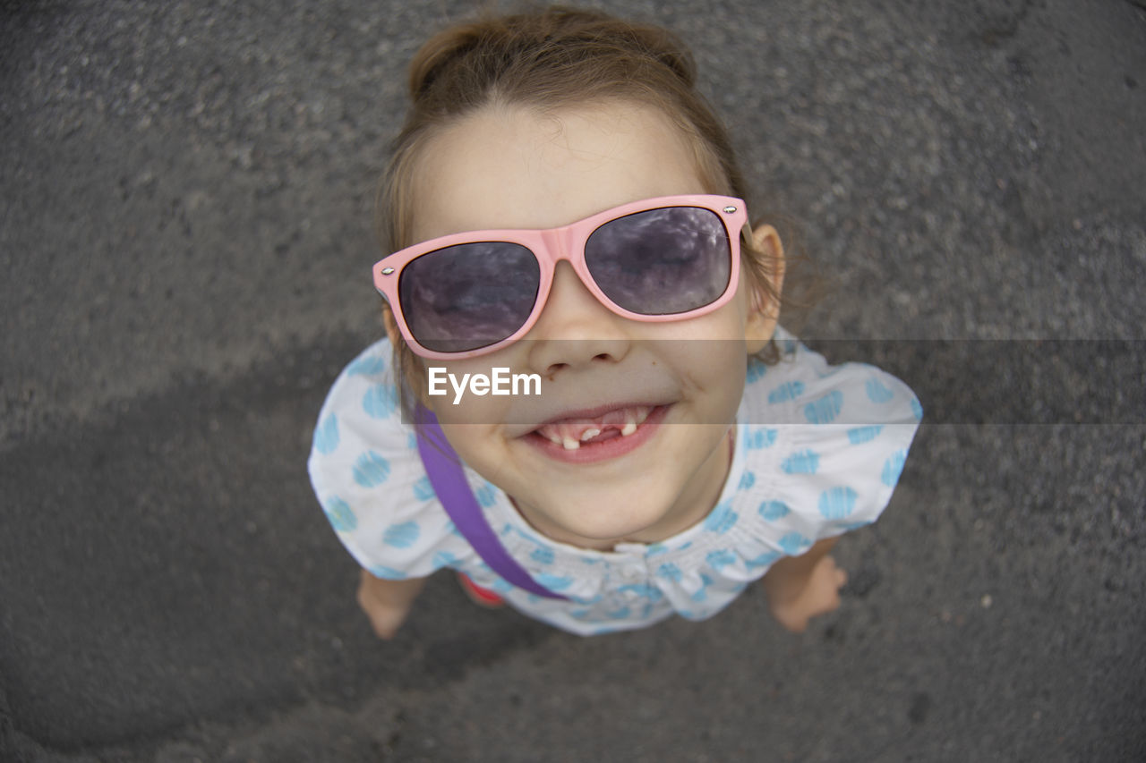 Portrait of gap toothed smiling girl standing outdoors