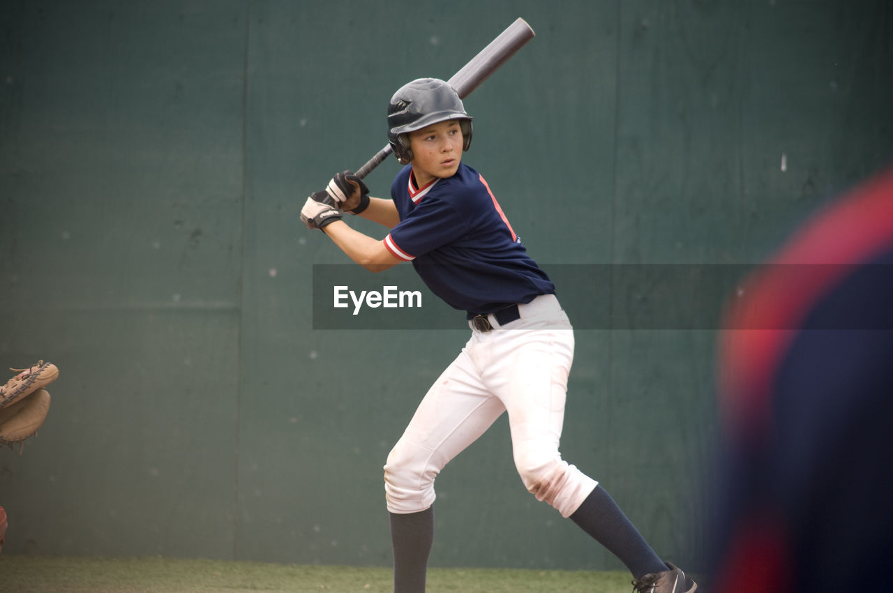 Young baseball player in batters box ready to swing