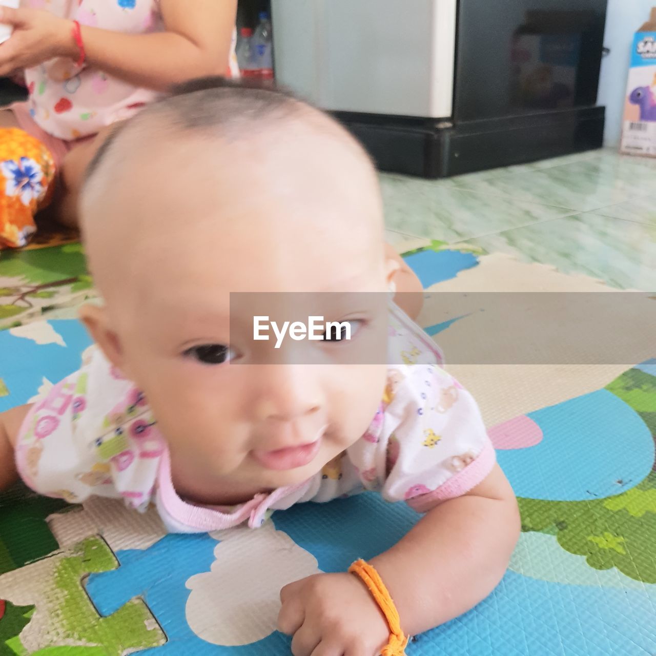 child, childhood, baby, lying down, toddler, innocence, portrait, one person, cute, skin, indoors, person, babyhood, high angle view, human face, headshot, lifestyles, clothing, relaxation, women, baby toys, day, toy, female, looking at camera, lying on back, nature, emotion, front view, baby clothing