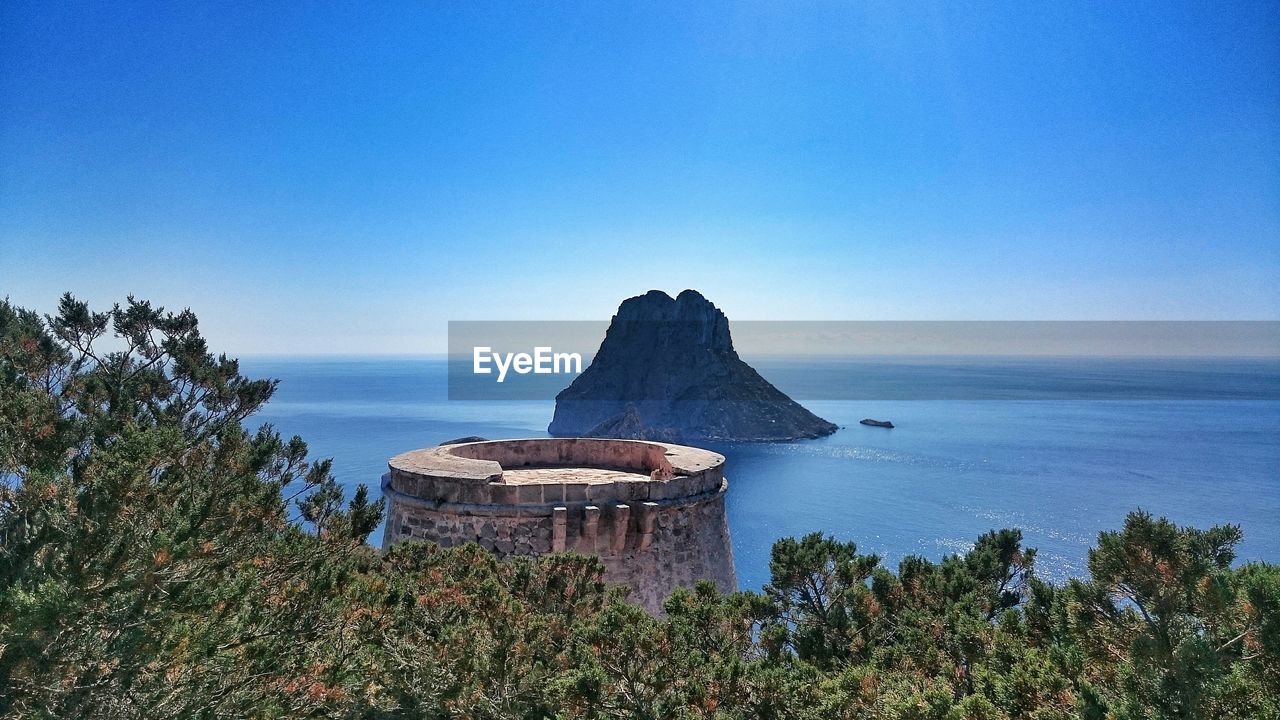 High angle view of calm sea against blue sky