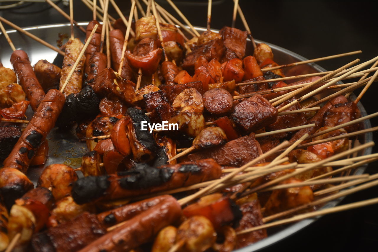 Close-up of grilled sausages, chicken dumplings and paprika.