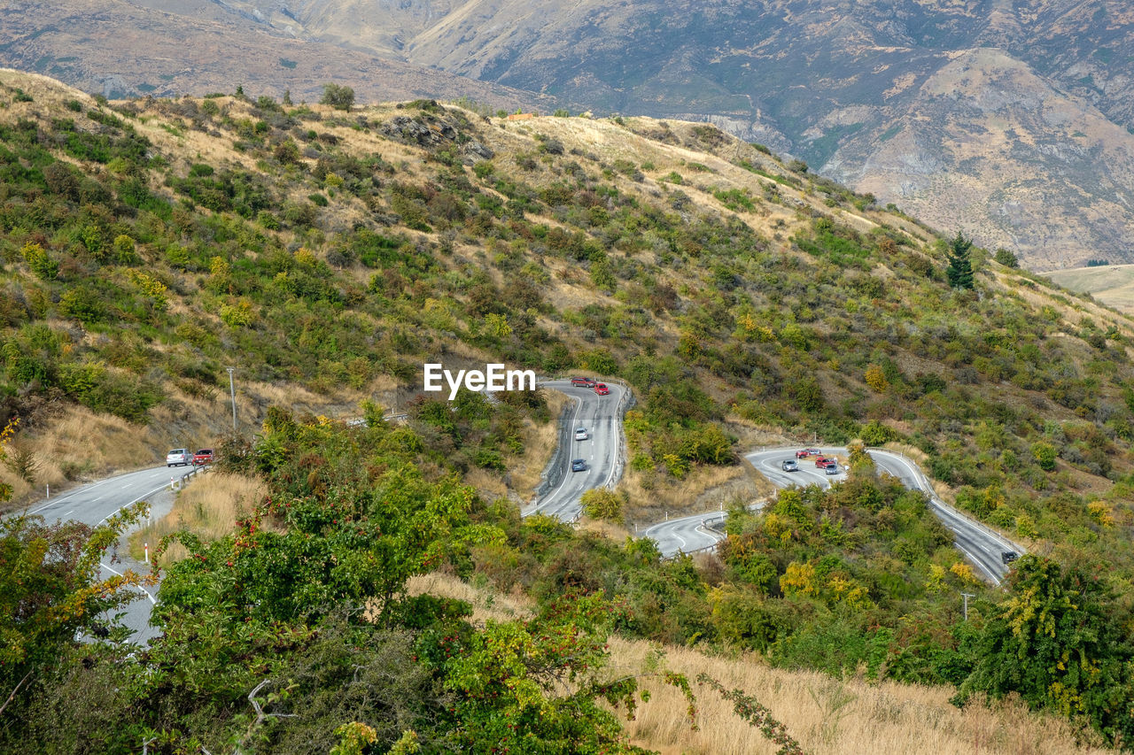 Curvy road cut through the hills of south island, new zealand