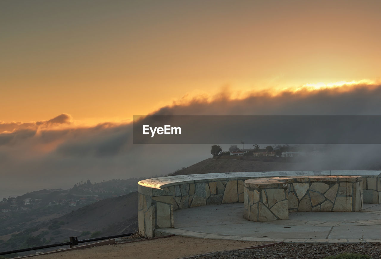 SCENIC VIEW OF MOUNTAINS AT SUNSET