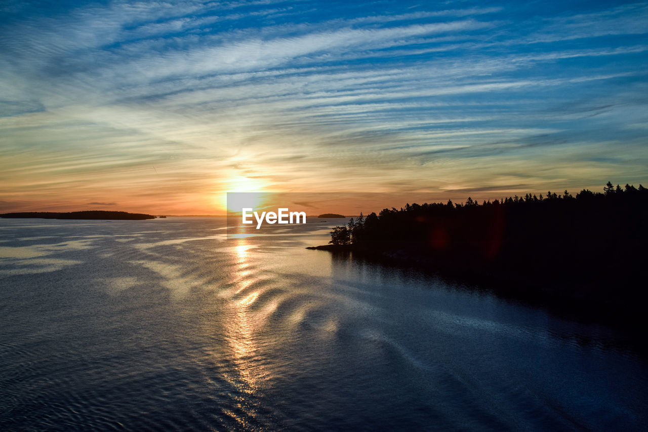 Scenic view of beach against sky during sunset