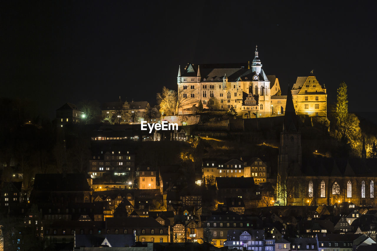 Illuminated cityscape against sky