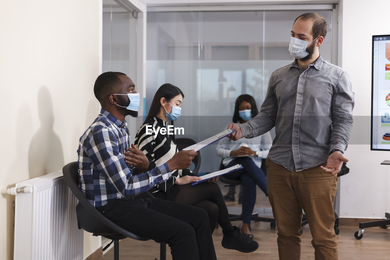 Business colleagues wearing mask working at office