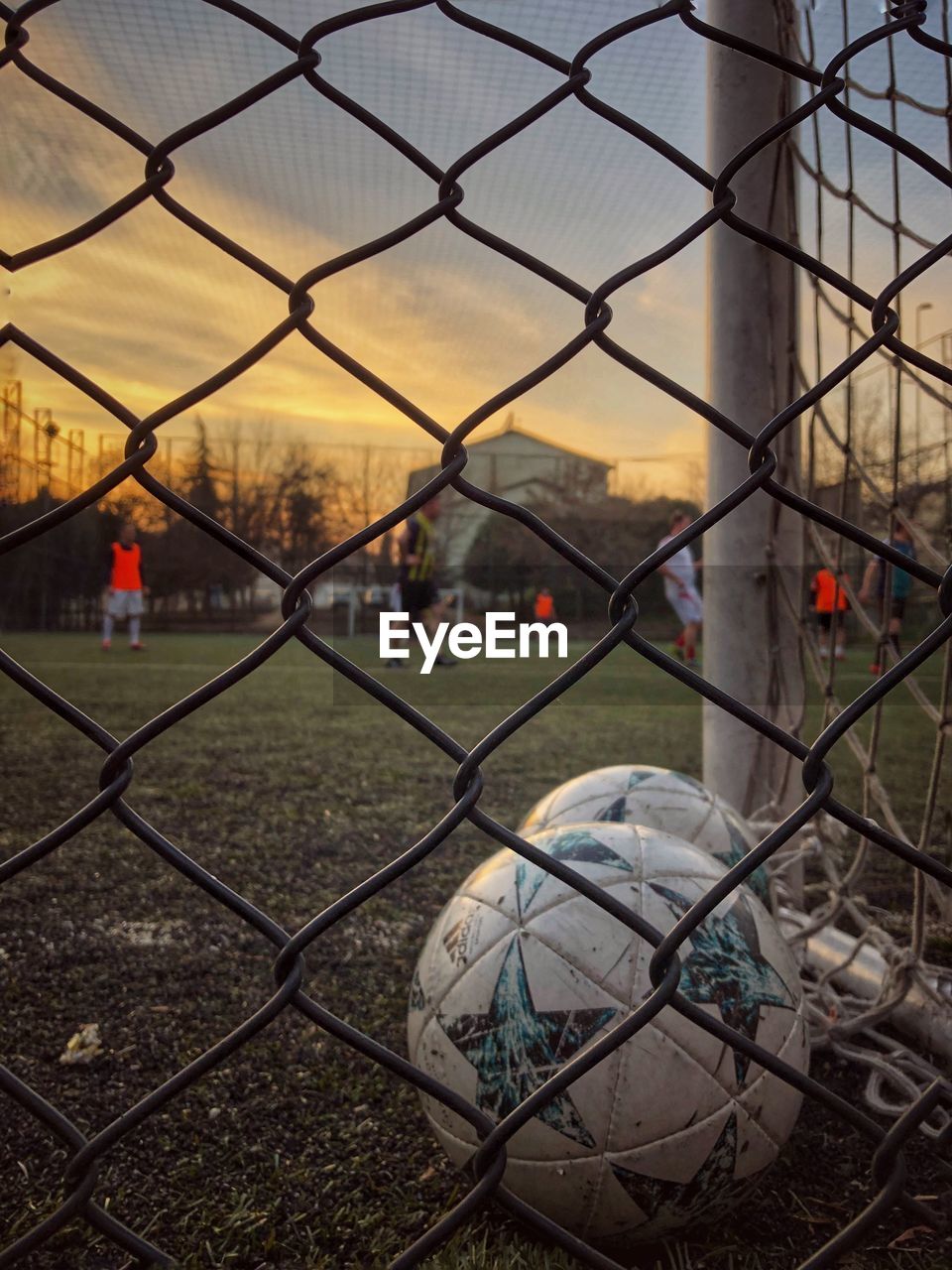 Cityscape seen through chainlink fence