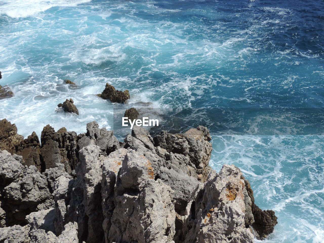 High angle view of rock formation by sea