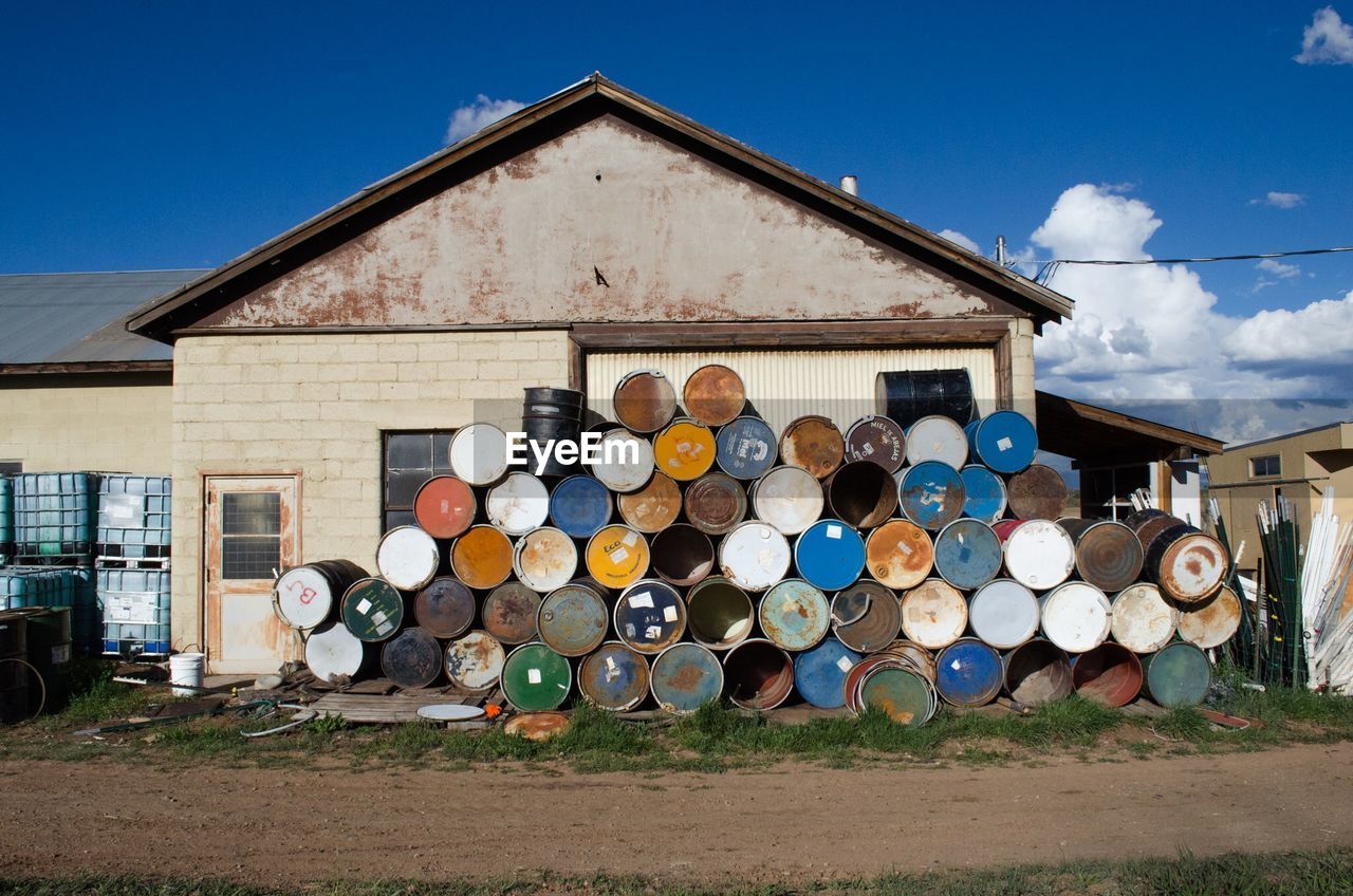 Stack of barrels against built structure