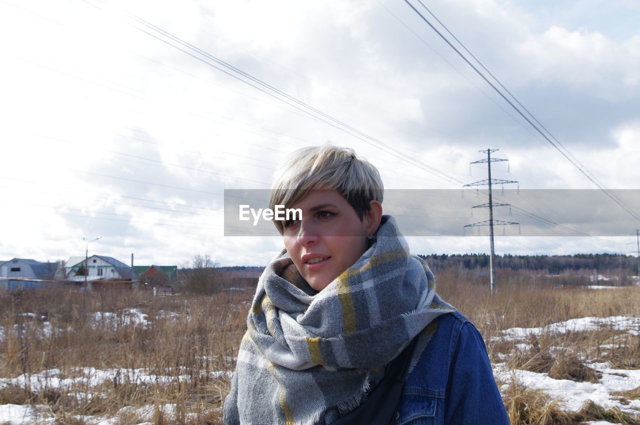 Portrait of woman on snow against sky