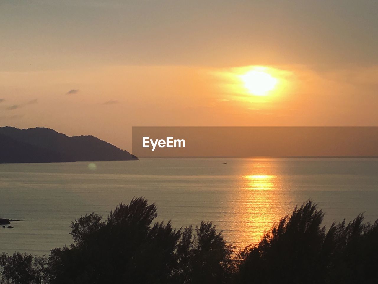 SCENIC VIEW OF SEA AND MOUNTAINS DURING SUNSET