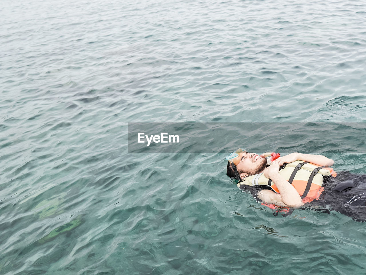 High angle view of woman lying in sea