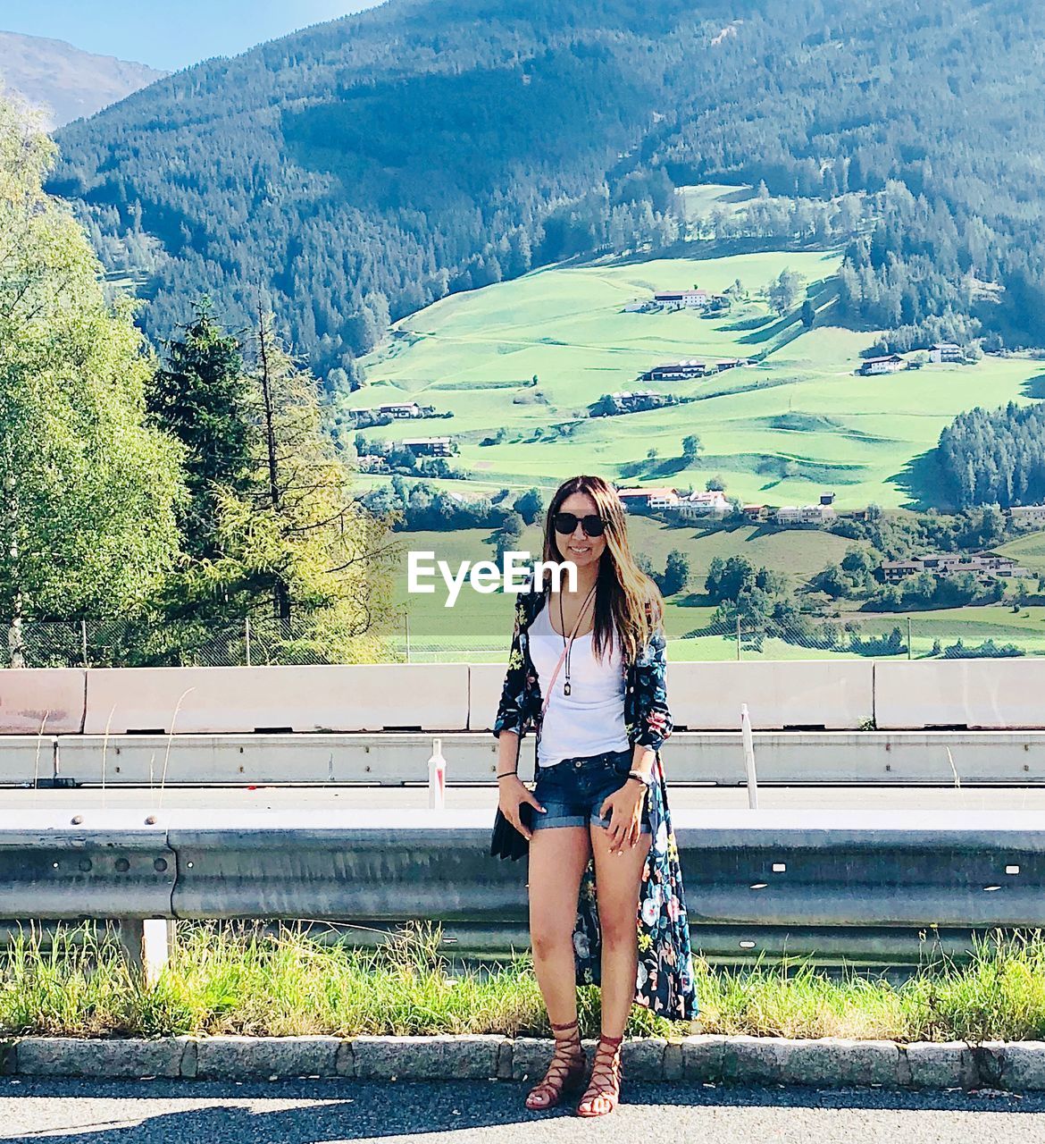 Full length portrait of woman against landscape and mountains