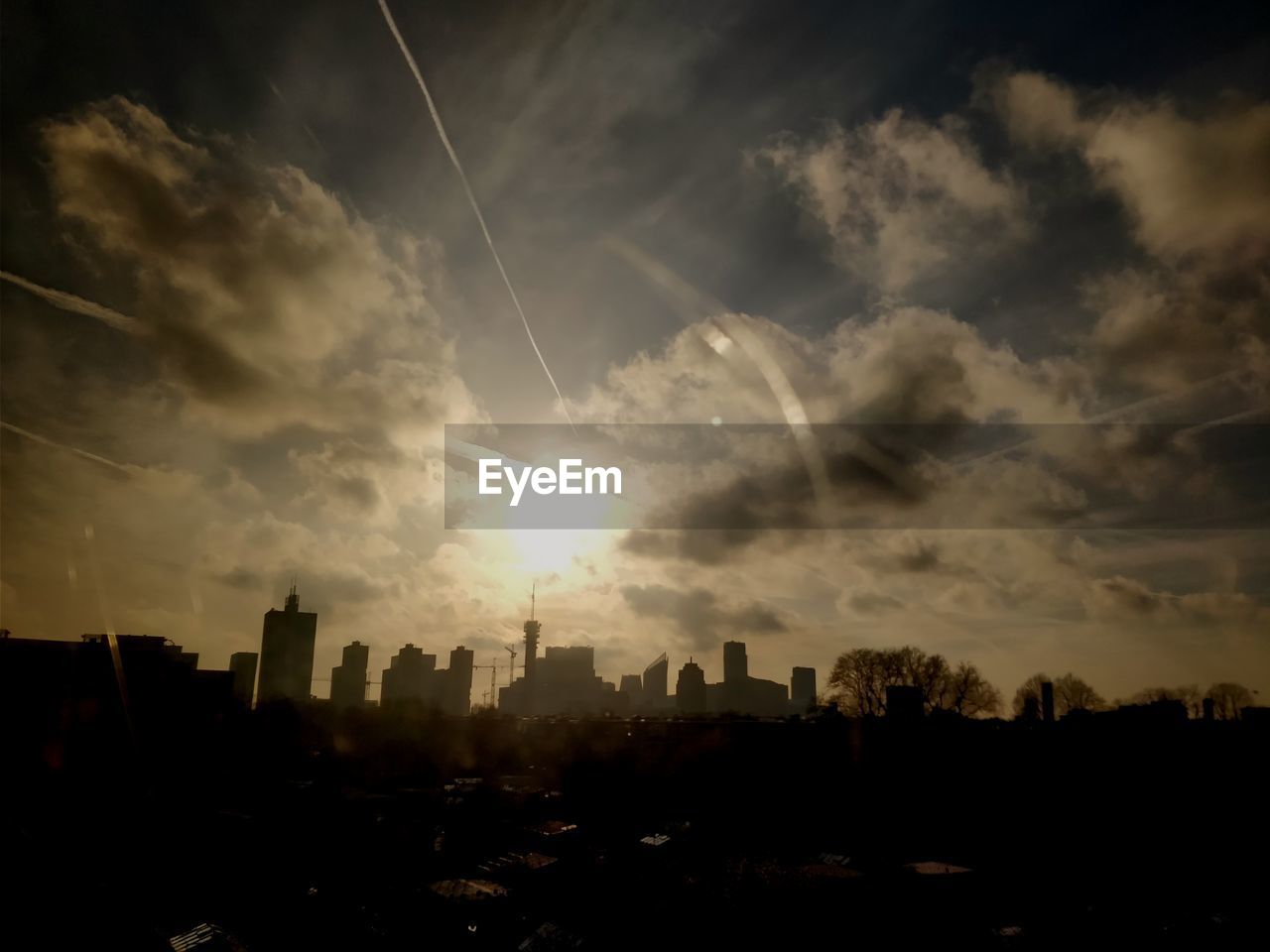 VIEW OF CITYSCAPE AGAINST CLOUDY SKY