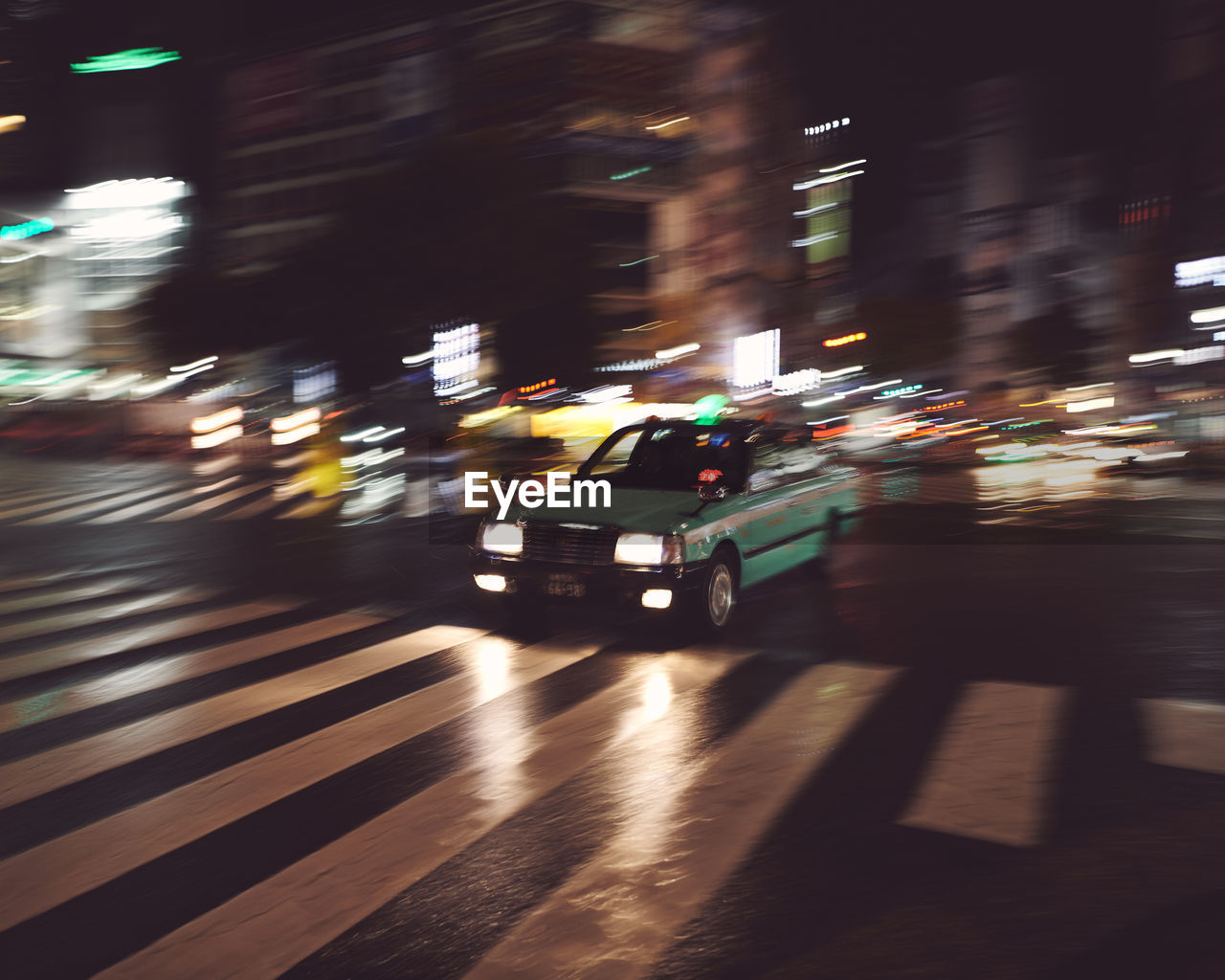 Cars on city street at night