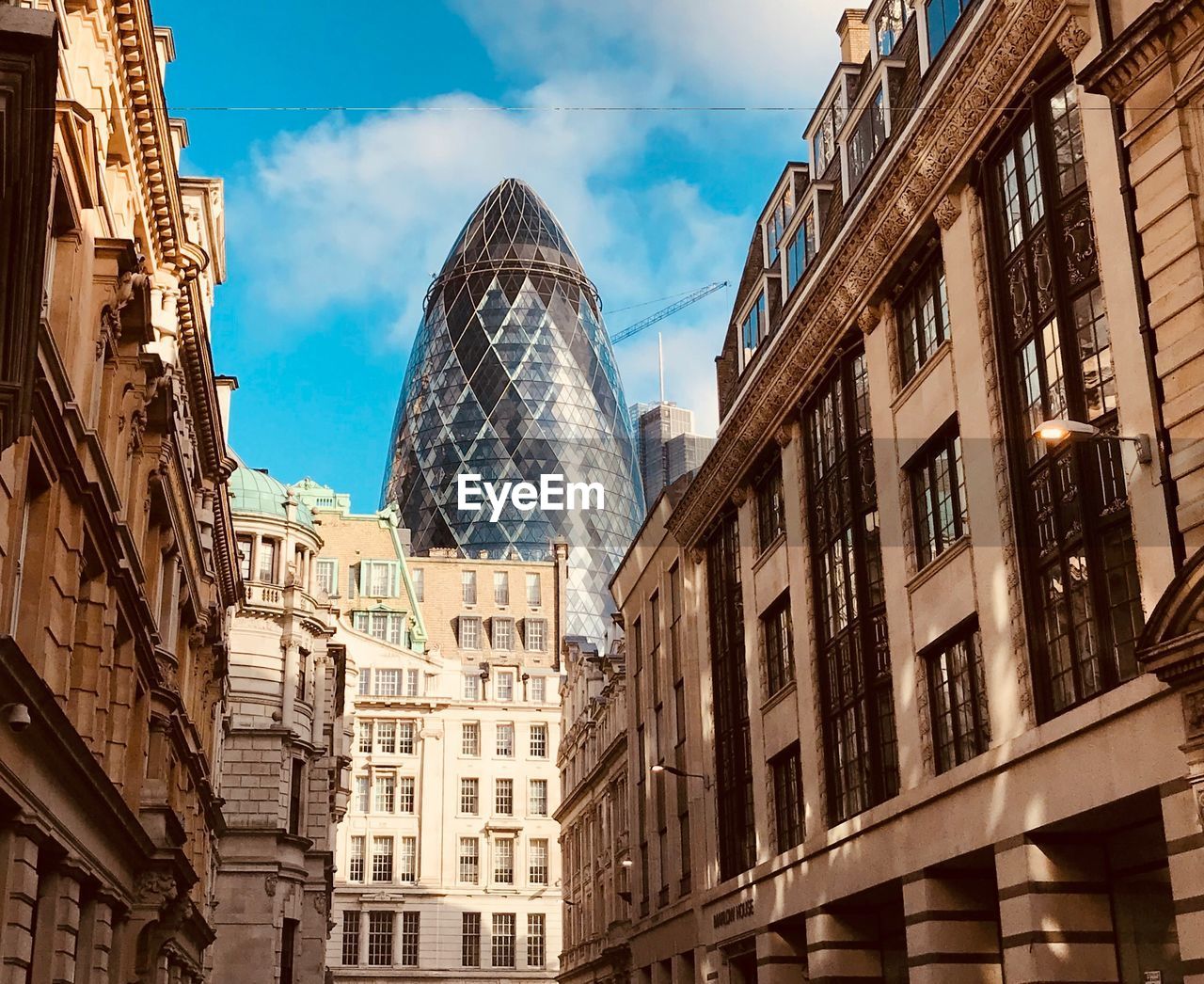 LOW ANGLE VIEW OF BUILDINGS IN CITY AGAINST SKY