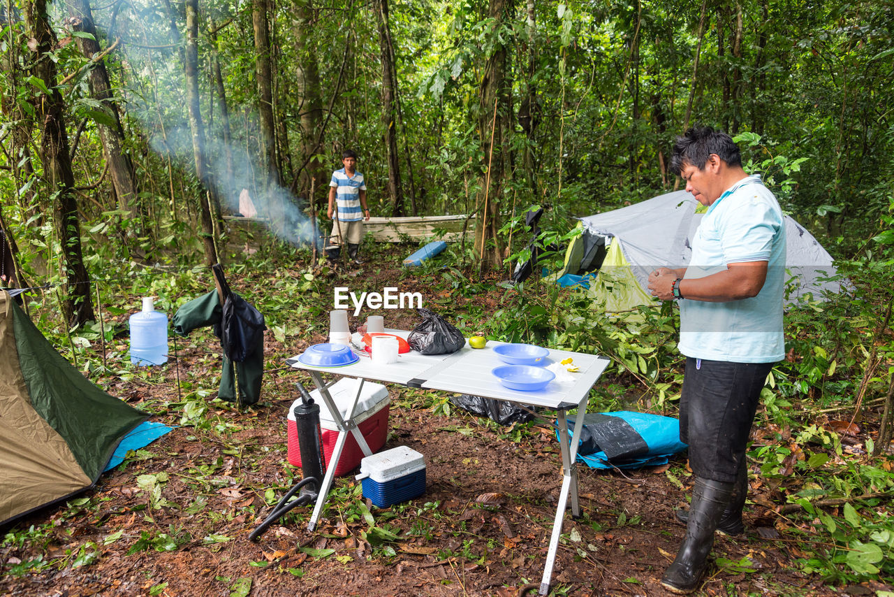 MAN WORKING AT FOREST