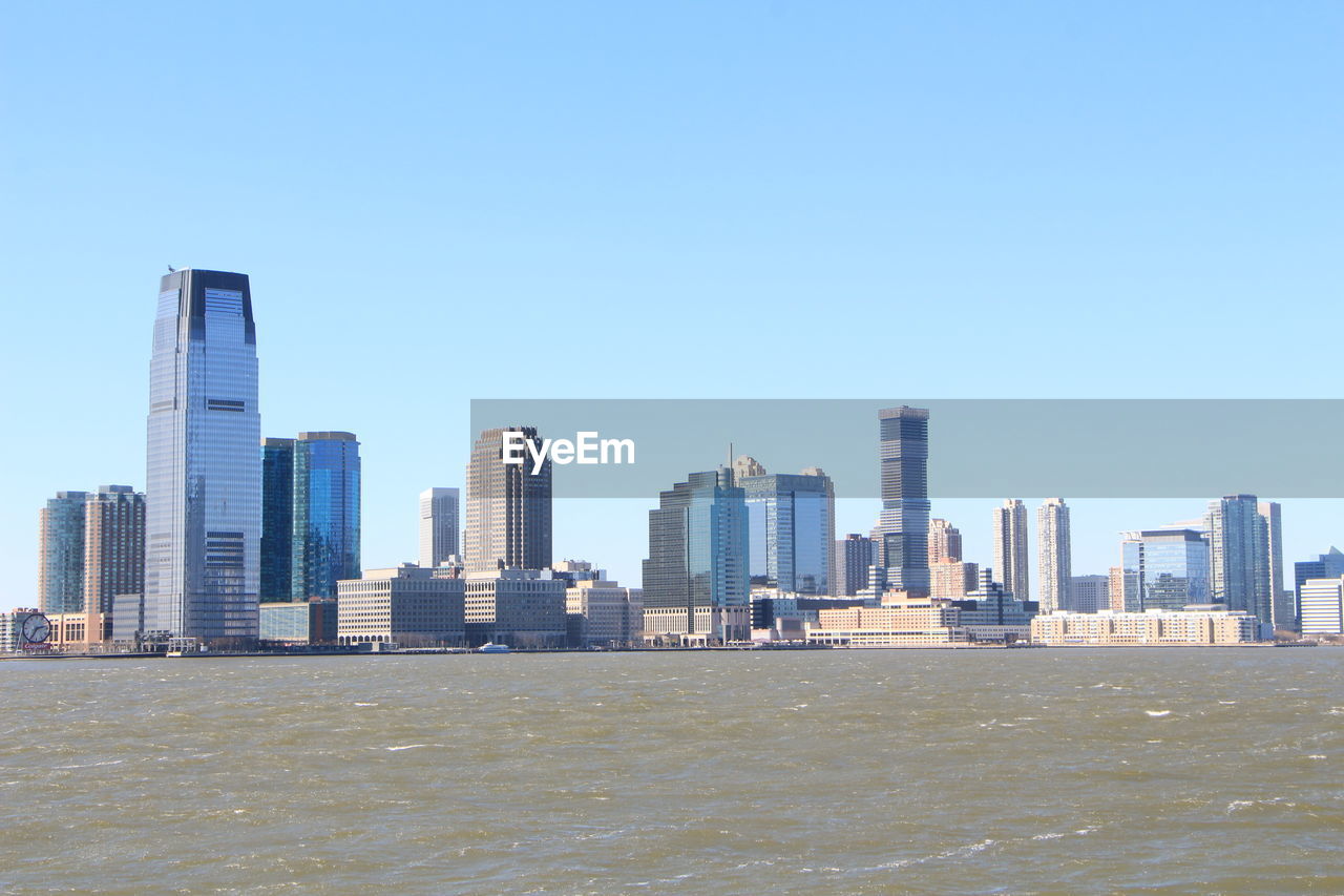 Buildings in city against clear sky