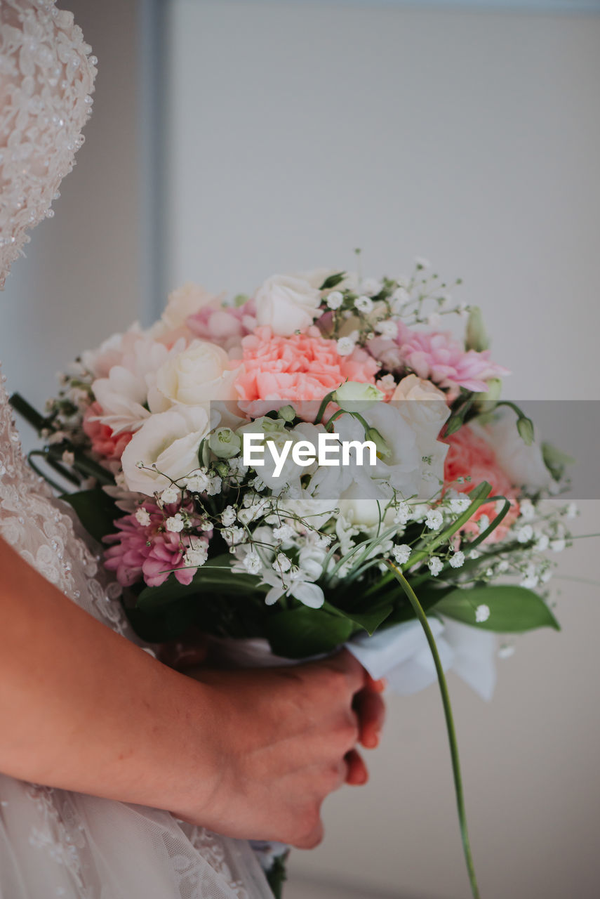 Close-up of hand holding flower bouquet