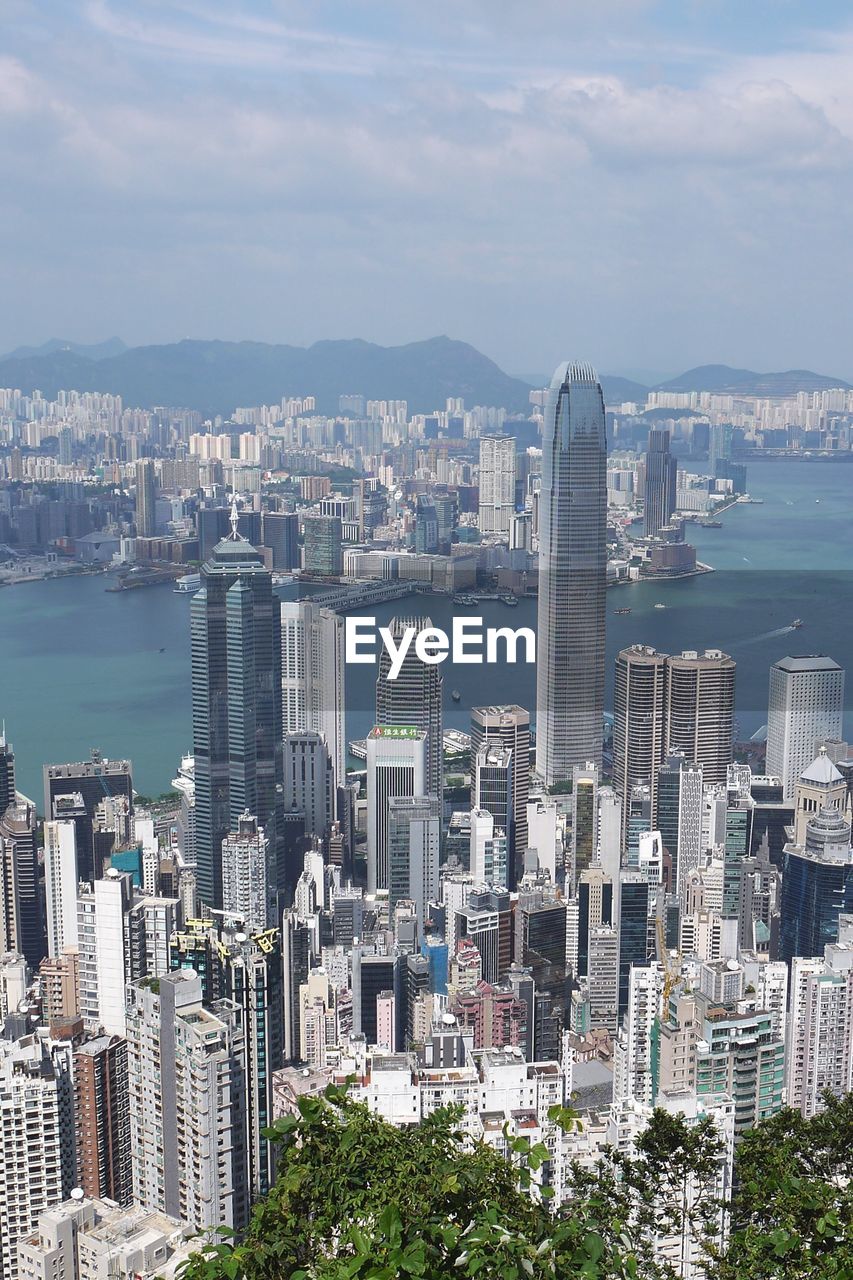 Aerial view of buildings in city against sky