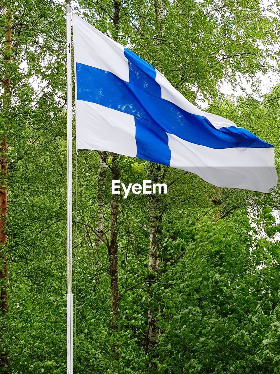 Low angle view of flag against blue sky