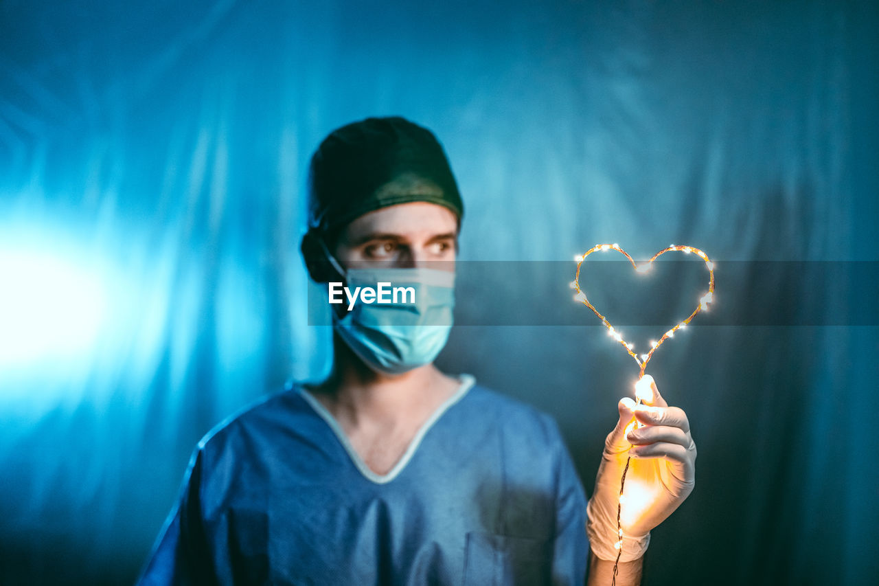 Doctor with luminous heart in hand