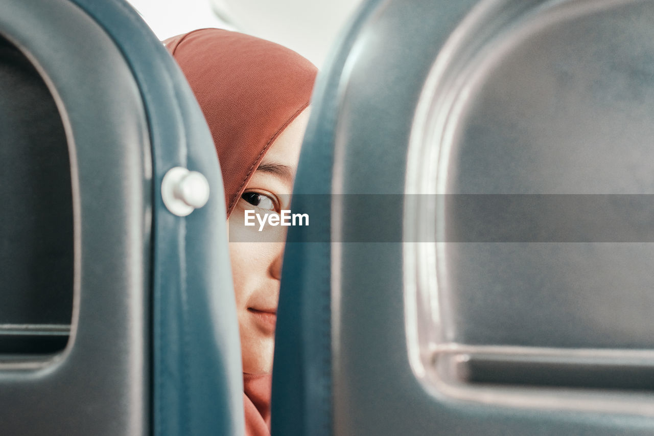 Close-up of woman seen through seat