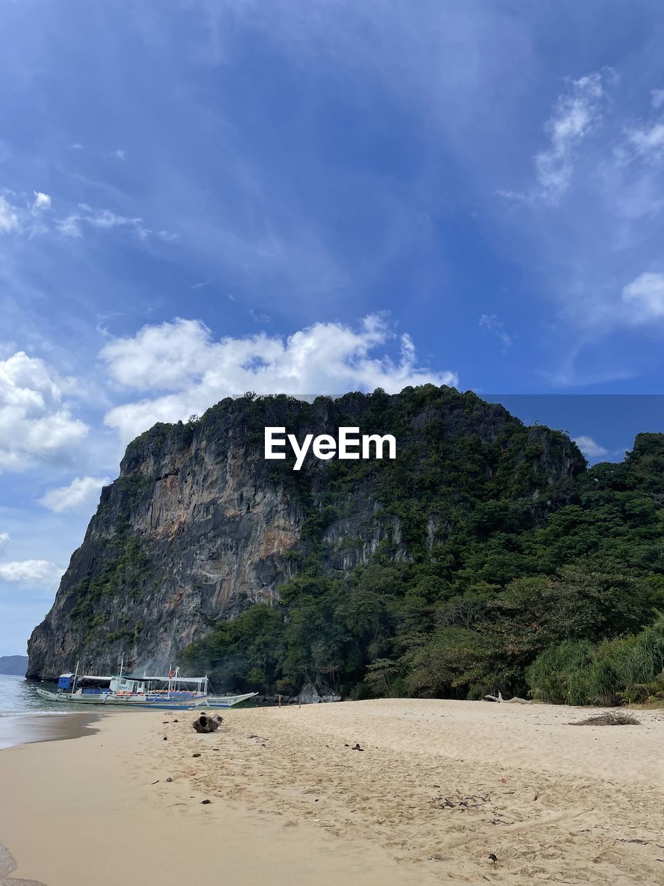 land, beach, sky, sea, water, scenics - nature, sand, cloud, beauty in nature, nature, coast, rock, body of water, ocean, shore, travel destinations, environment, coastline, mountain, cliff, travel, tranquility, landscape, holiday, trip, blue, vacation, tourism, tranquil scene, no people, tree, outdoors, non-urban scene, island, bay, rock formation, plant, idyllic, day, seascape, summer, terrain, bay of water, water's edge