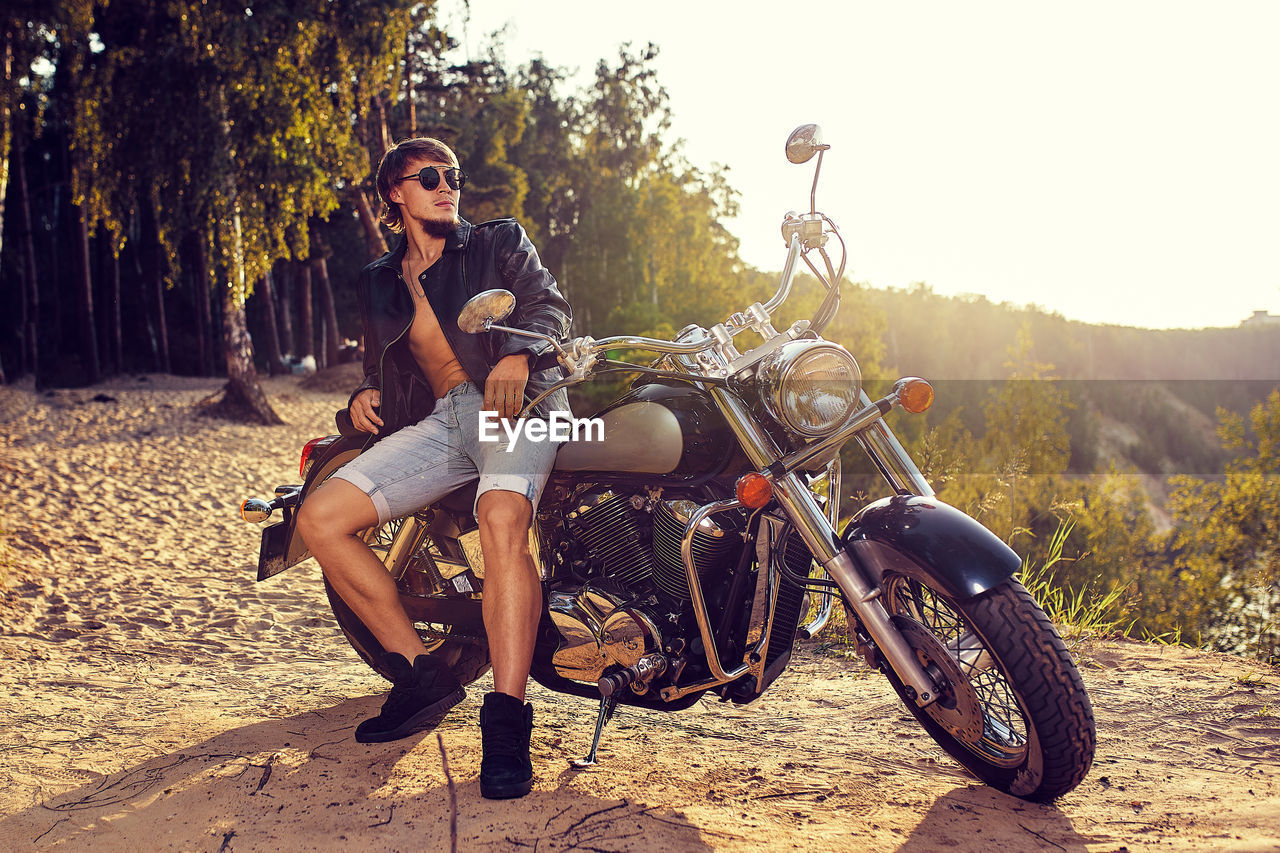 WOMAN RIDING MOTORCYCLE ON ROAD