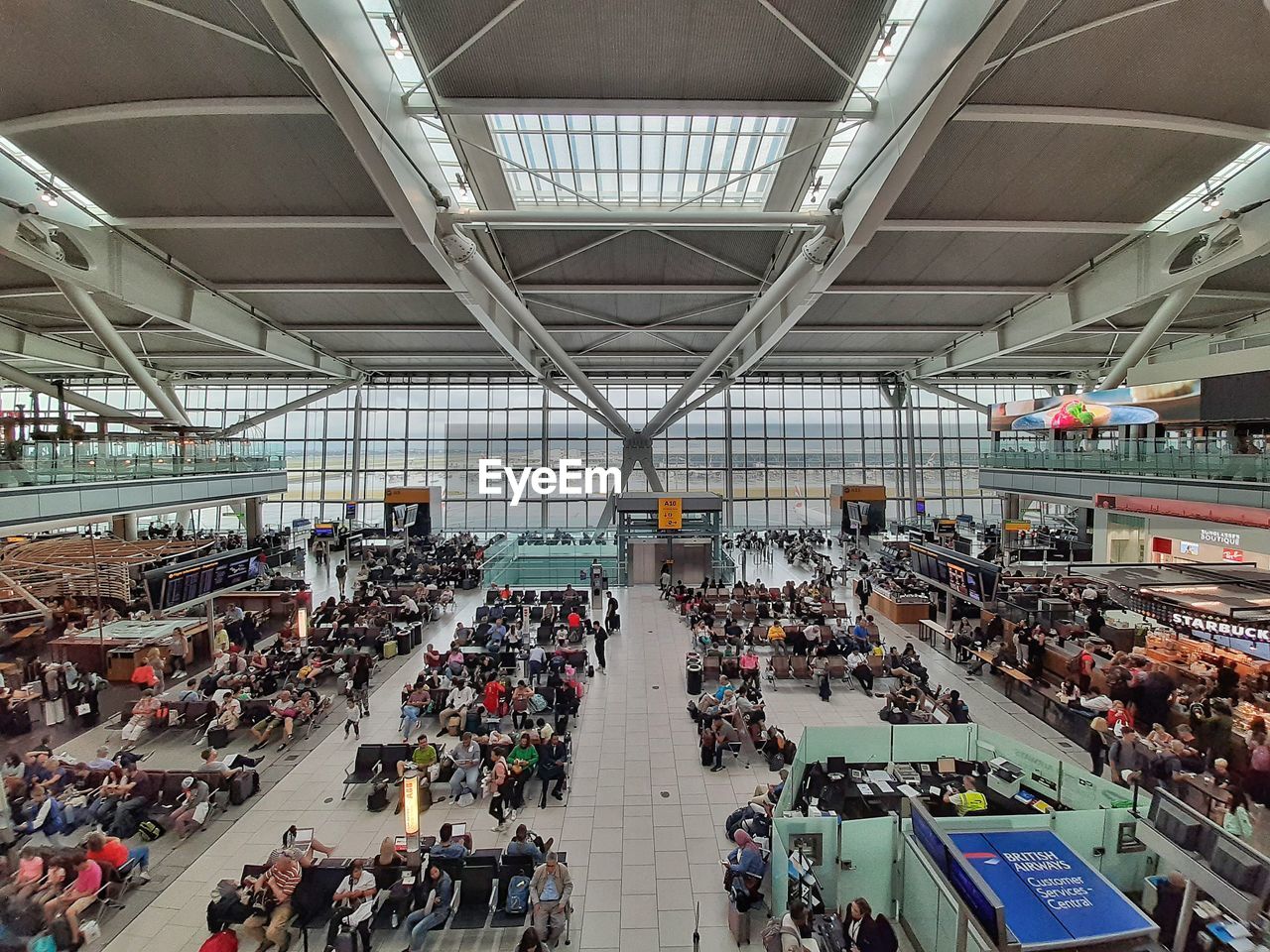 HIGH ANGLE VIEW OF PEOPLE WAITING FOR SALE AT STATION