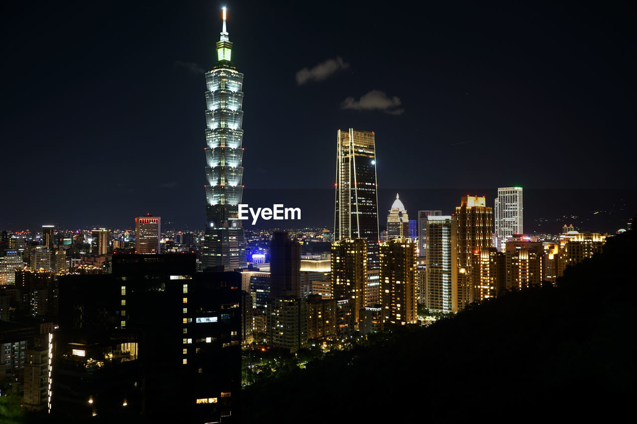 high angle view of illuminated buildings in city at night