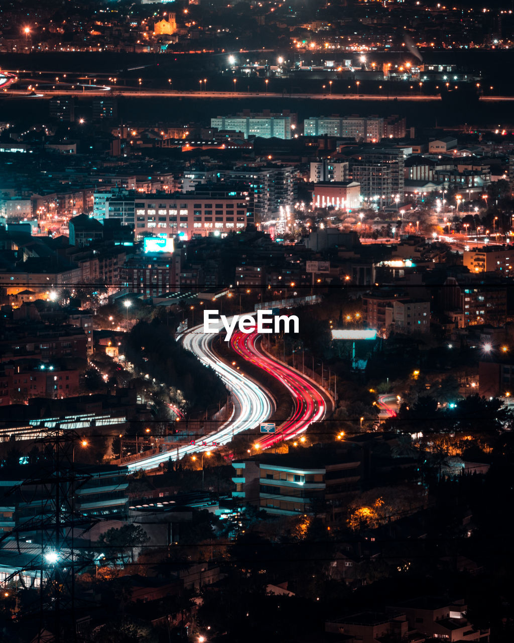 High angle view of traffic light trails and  illuminated buildings in city at night