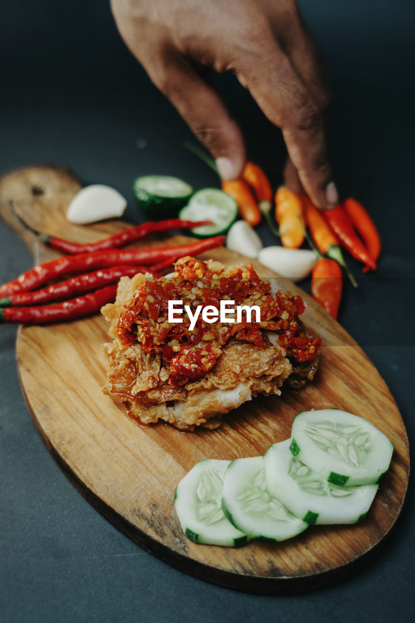 Cropped hand of person preparing food