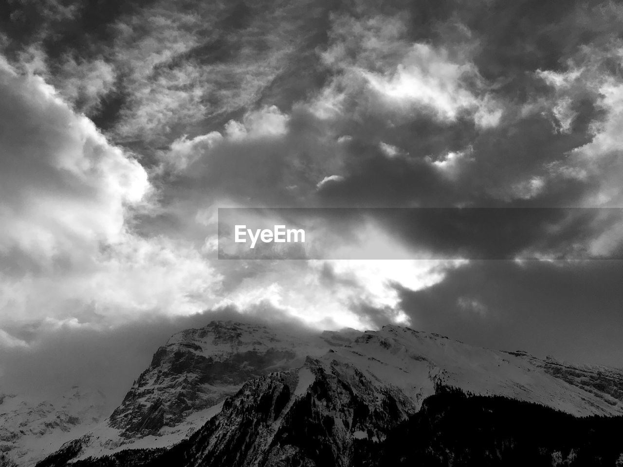 Low angle view of snowcapped mountains against sky