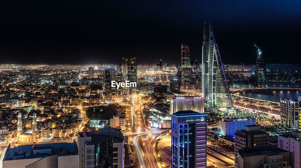 High angle view of city lit up at night