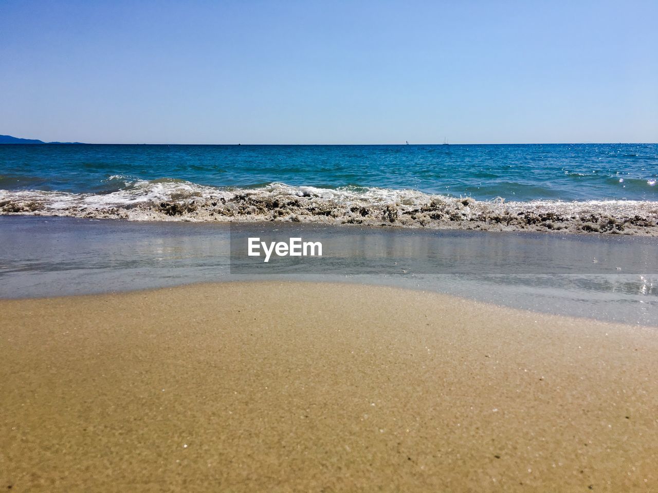 Scenic view of beach against clear sky