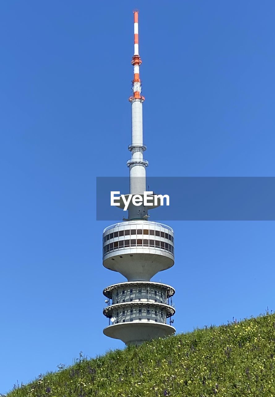 LOW ANGLE VIEW OF COMMUNICATIONS TOWER AGAINST SKY