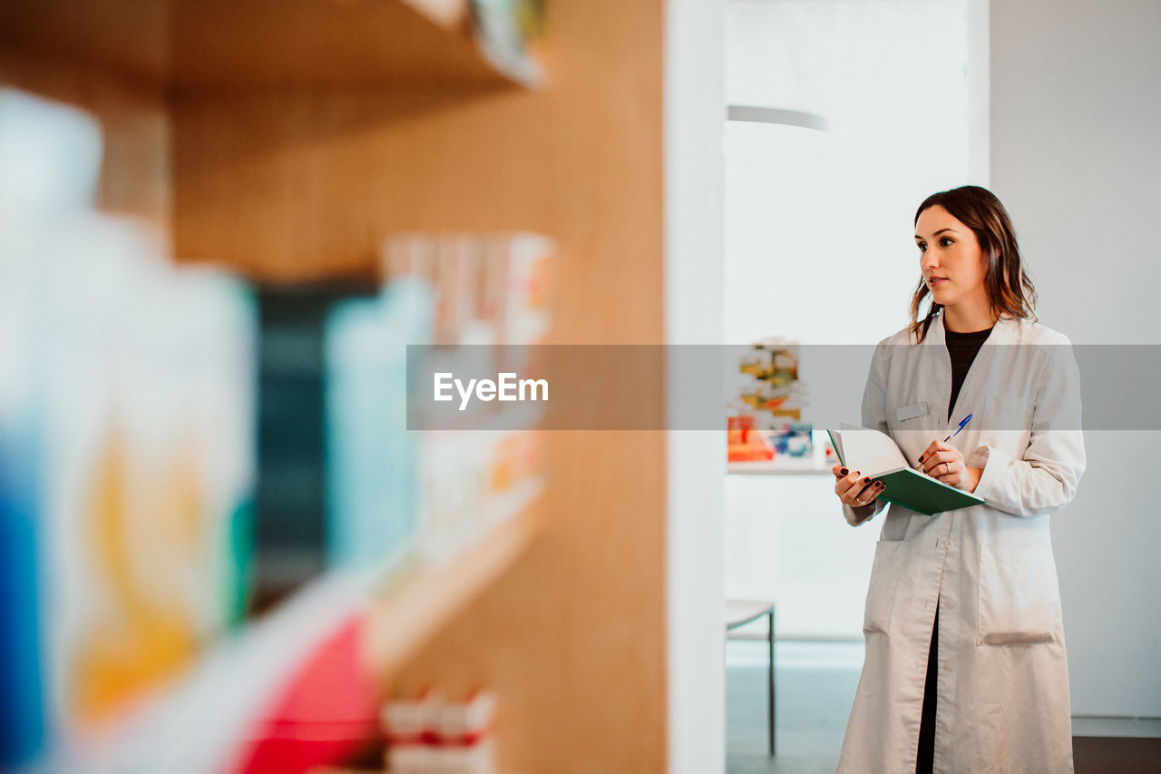 Female pharmacist working at store