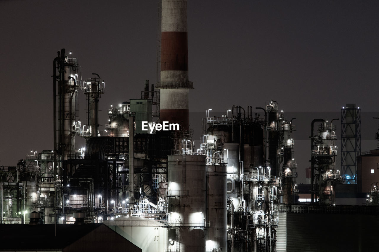 VIEW OF FACTORY AGAINST SKY AT NIGHT