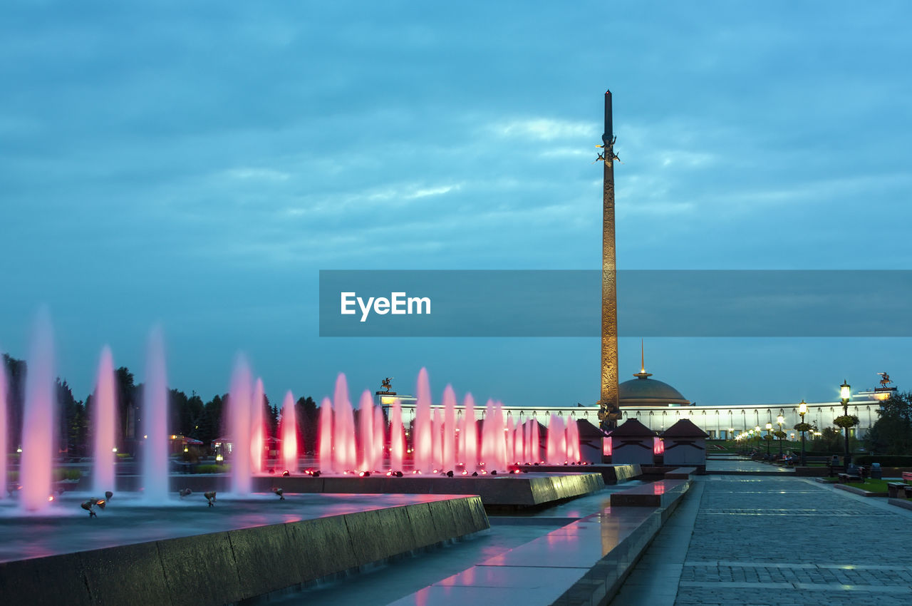 ILLUMINATED BUILDINGS AGAINST SKY AT DUSK