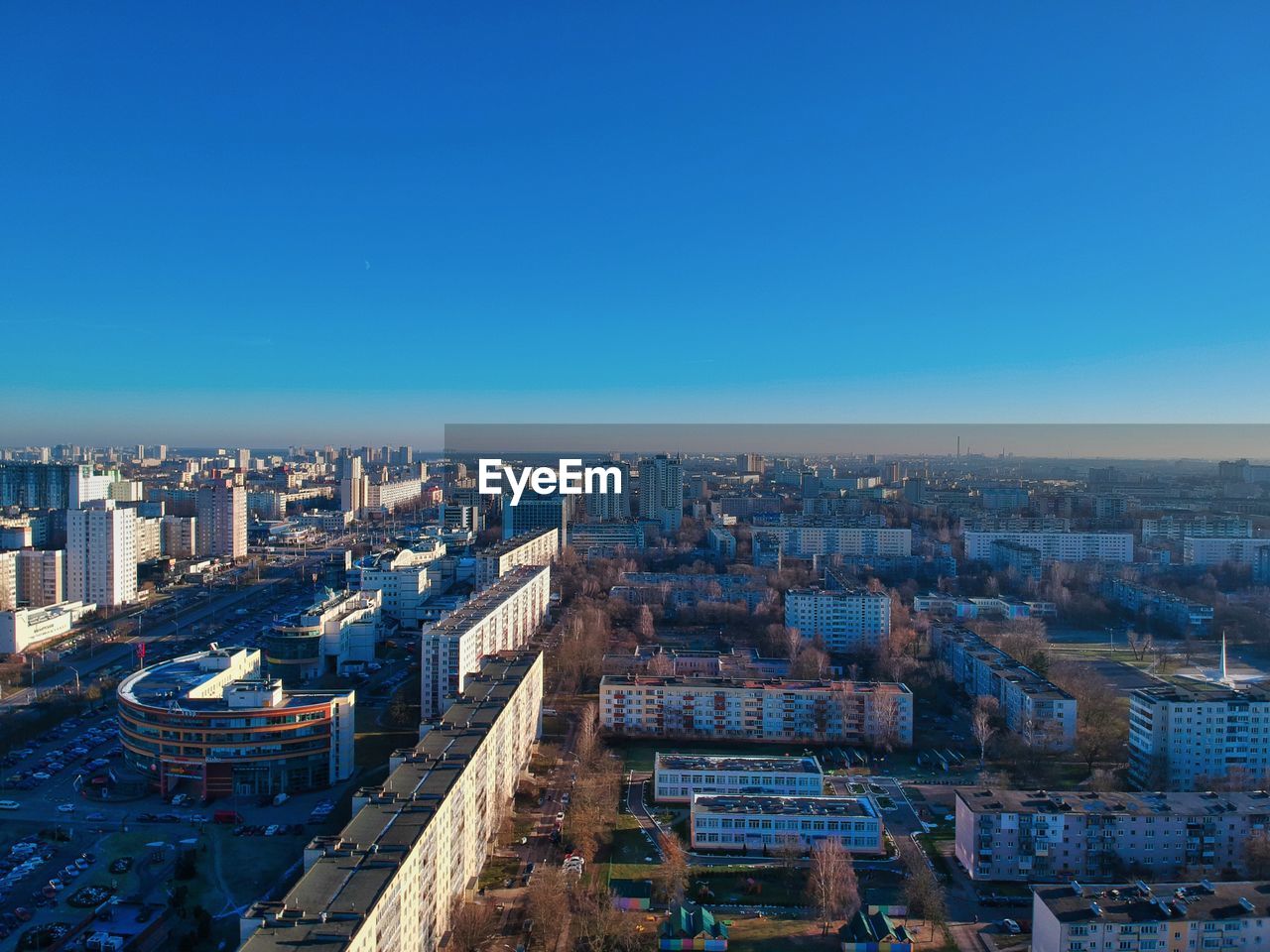 High angle view of buildings against clear blue sky