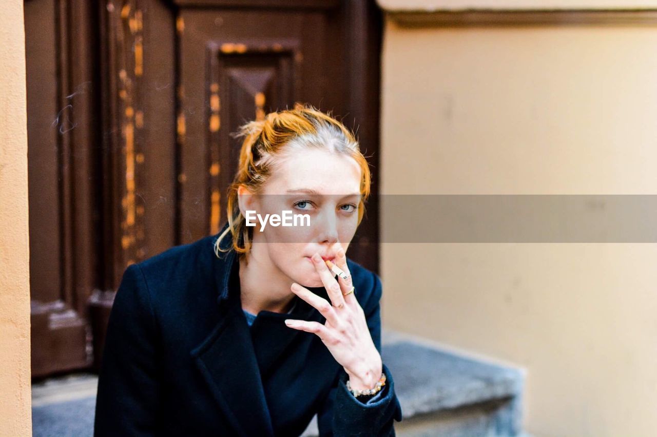 Young woman smoking cigarette