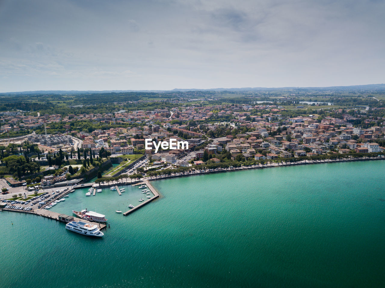 High angle view of buildings by sea against sky